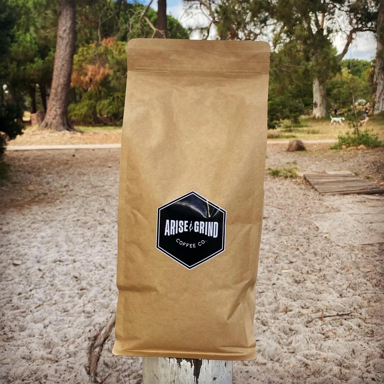 An Arise & Grind coffee bag with the original Coffee Co. mark